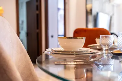 a glass table with a cup and plates on it at Chic blue studio au cœur deCasablanca in Casablanca