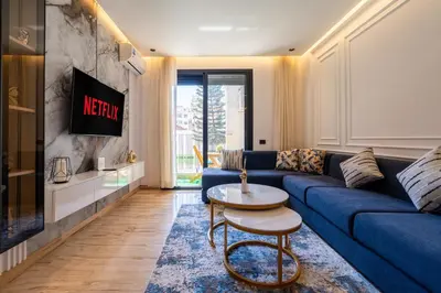 a living room with a blue couch and a tv at Chic blue studio au cœur deCasablanca in Casablanca