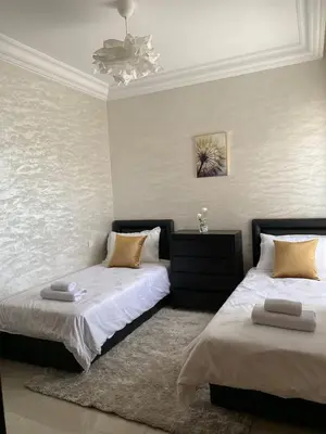 a bedroom with two beds and a ceiling at Appartement Spacieux & Moderne, 2 min Gare, 10 min Plage, Parking Gratuit in Casablanca