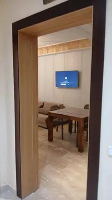a living room with a table and a couch at Macha allah in Bouznika