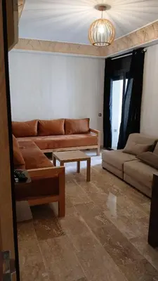 a living room with two couches and a table at Macha allah in Bouznika