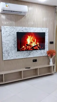 a fireplace in a living room with a fire at Studio Marzouga in Deroua