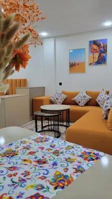 a living room with couches and a table at Studio Marzouga in Deroua