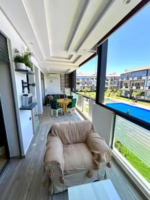a living room with a couch and a large window at Appartement à louer in Nouaceur