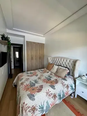a bedroom with a bed with a floral bedspread at Appartement à louer in Nouaceur