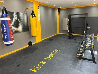 a fitness room with a gym with a punching bag at Appartement à louer in Nouaceur