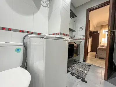 a small kitchen with a white refrigerator in a room at Central Studio Casablanca in Casablanca