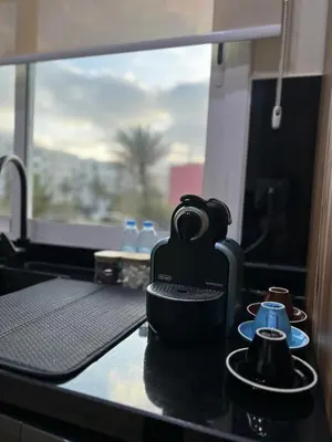 a coffee maker sitting on a counter with a window at Appartement élégant avec vue imprenable sur la corniche de Casablanca in Casablanca