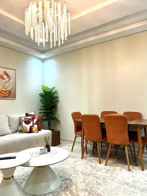 a living room with a table and a couch at Appartement élégant avec vue imprenable sur la corniche de Casablanca in Casablanca