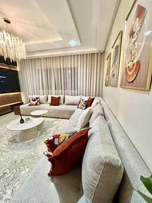 a living room with a couch and a table at Appartement élégant avec vue imprenable sur la corniche de Casablanca in Casablanca