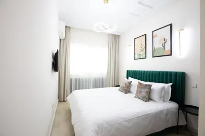 a bedroom with a white bed and a window at Appartement Luxueux pour Famille - Quartier Abdelmoumen in Casablanca
