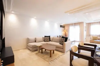 a living room with a couch and a table at Appartement Luxueux pour Famille - Quartier Abdelmoumen in Casablanca