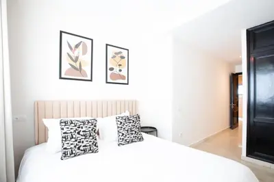 a bedroom with a white bed with two pillows at Appartement Luxueux pour Famille - Quartier Abdelmoumen in Casablanca