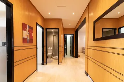 a bathroom with wood paneled walls and a toilet at Appartement Luxueux pour Famille - Quartier Abdelmoumen in Casablanca