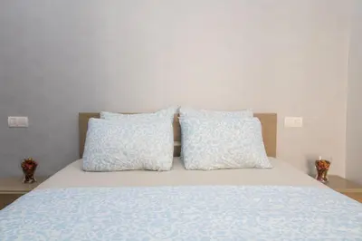a bed with two blue pillows on top of it at Mamounia Horizon in Casablanca