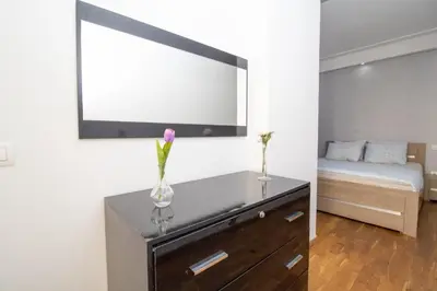 a room with a bed and a dresser with a mirror at Mamounia Horizon in Casablanca