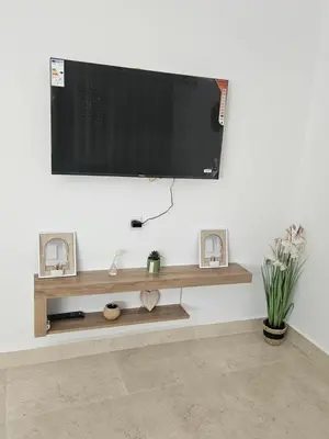 a flat screen tv hanging on a wall at Apartamento Bonito in Rabat