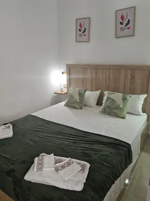 a bedroom with a large bed with two towels on it at Apartamento Bonito in Rabat