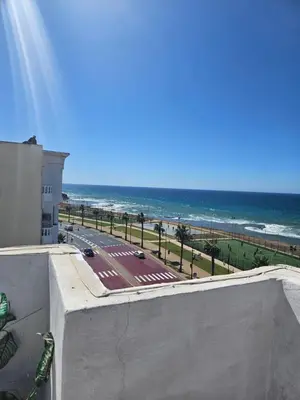 a view of the beach from the balcony of a building at Apartamento Bonito in Rabat
