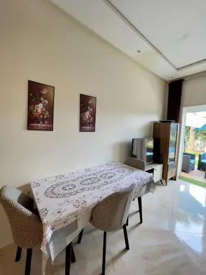 a dining room with a table and chairs at Appartement Pied dans l'eau avec terrasse-Casa bay in Sidi Rahal
