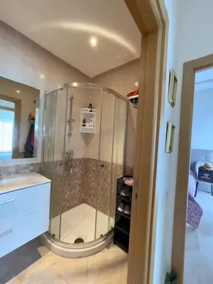 a shower with a glass enclosure in a bathroom at Appartement Pied dans l'eau avec terrasse-Casa bay in Sidi Rahal