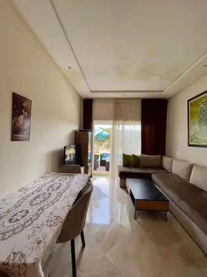 a living room with a bed and a couch at Appartement Pied dans l'eau avec terrasse-Casa bay in Sidi Rahal