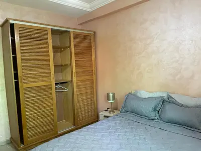 a bedroom with a bed and a book shelf at Beach palace 1 between sea pool and city center in Mohammedia