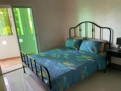 a bed with a blue comforter in a bedroom at Beach palace 1 between sea pool and city center in Mohammedia