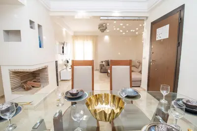 a dining room and living room with a glass table at Anfa Dream in Casablanca