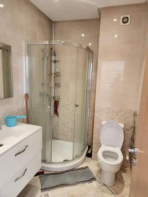a bathroom with a shower with a toilet and a sink at LES JARDINS DE BOUZNIKA PREMIUm in Bouznika