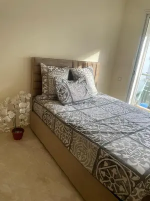 a bedroom with a bed with pillows on it at LES JARDINS DE BOUZNIKA PREMIUm in Bouznika