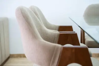 a pair of white boots sitting on a chair at Appartement avec Piscine dans Résidence Privée in Dar Bouazza