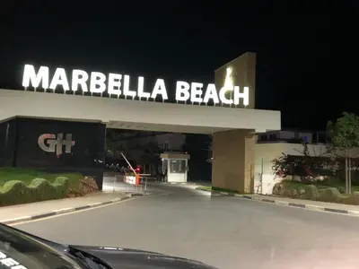 a car parked in front of a marbella beach sign at Eden Prestige in Bouznika