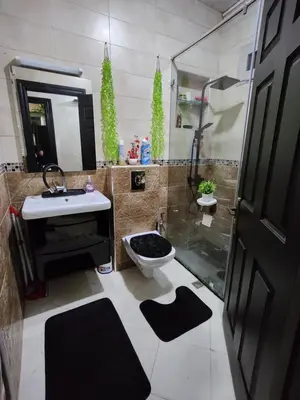 a bathroom with a shower and a toilet and a sink at Chambre pour une femme ou pour un couple dans un Appartement de luxe bien situé et bien équipé in Rabat
