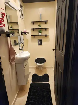 a bathroom with a toilet and a sink at Chambre pour une femme ou pour un couple dans un Appartement de luxe bien situé et bien équipé in Rabat