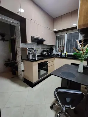 a kitchen with a black counter top in a room at Chambre pour une femme ou pour un couple dans un Appartement de luxe bien situé et bien équipé in Rabat