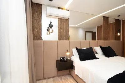a bedroom with a large white bed with black pillows at Magnífico apartamento in Casablanca
