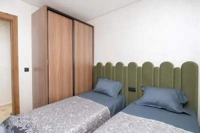 a bedroom with two beds and a headboard at Magnífico apartamento in Casablanca
