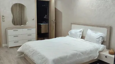 a bedroom with a white bed and a mirror at Appartement moderne centre Casablanca in Casablanca