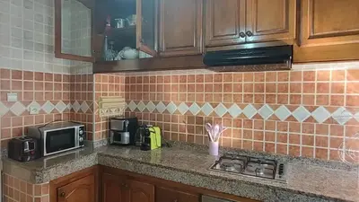 a kitchen with a counter with a microwave and a stove at Appartement moderne centre Casablanca in Casablanca
