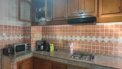 a kitchen with a counter with a microwave and a stove at Appartement moderne centre Casablanca in Casablanca