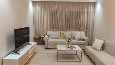a living room with a couch and a tv at Appartement moderne centre Casablanca in Casablanca