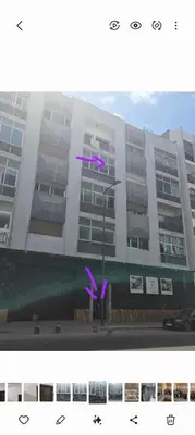 a building with purple arrows on the side of it at Appartement moderne centre Casablanca in Casablanca