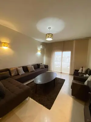 a living room with a couch and a coffee table at Appartement meublé in Temara