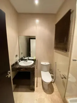 a bathroom with a toilet and a sink at Appartement meublé in Temara