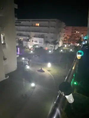 a view of a city street at night with lights at Bel appartement vue piscine in Bouznika