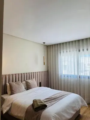 a bedroom with a large bed and a window at Bright & Cozy Apt with City View in Casablanca