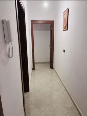 a hallway with a door and a tile floor at A coté hôpital M6,Proche d'Aéroport et la gare bouskoura in Bouskoura
