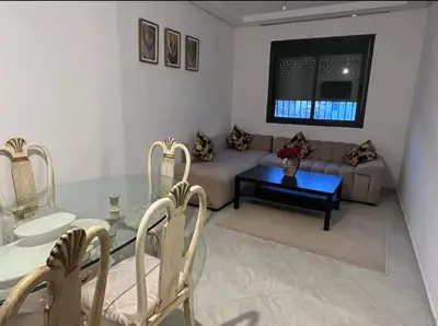 a living room with a glass table and a couch at A coté hôpital M6,Proche d'Aéroport et la gare bouskoura in Bouskoura