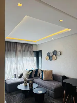 a living room with a couch and a table at Charming Apartment With City View in Casablanca